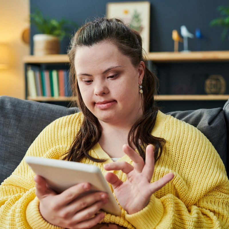 Young Woman With Disability Using Tablet